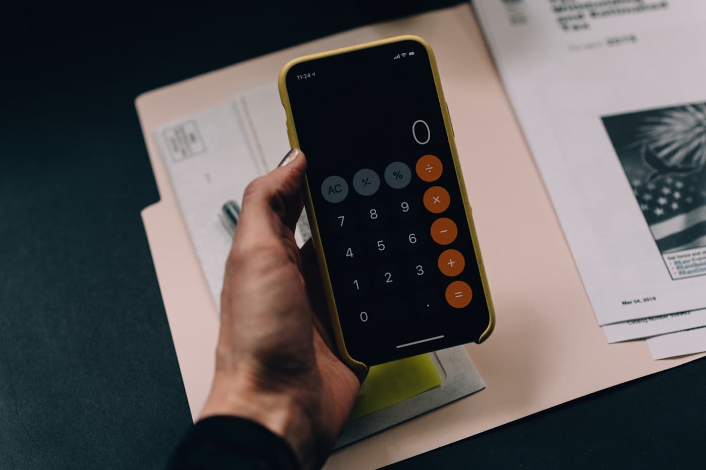 Calculator app and financial paperwork used for bookkeeping