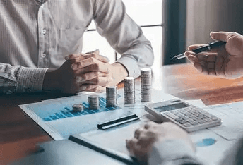 Business finance meeting with charts, calculator, and cash flow planning