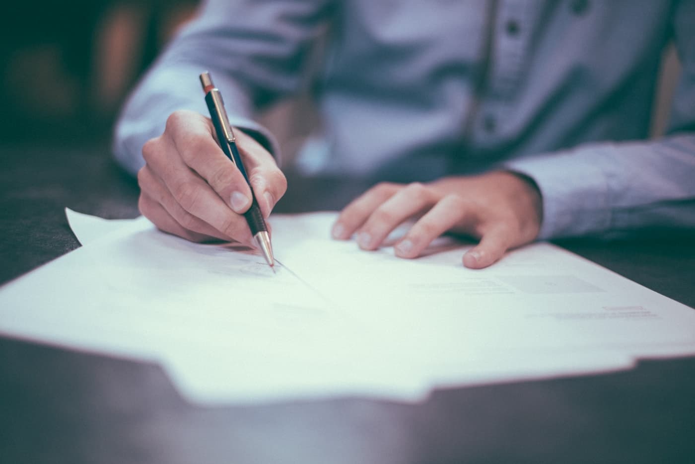 Professional signing financial paperwork